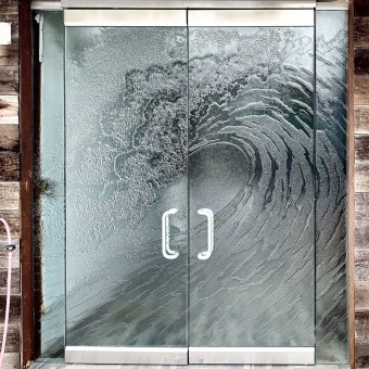 Cast glass wave on a set of double entryway doors